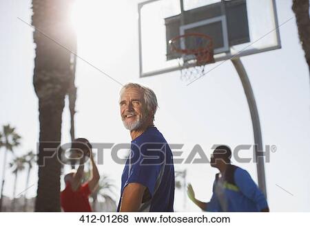 Older men playing basketball on court View Large Photo Image Stock Photo - Older men playing basketball on court. Fotosearch
