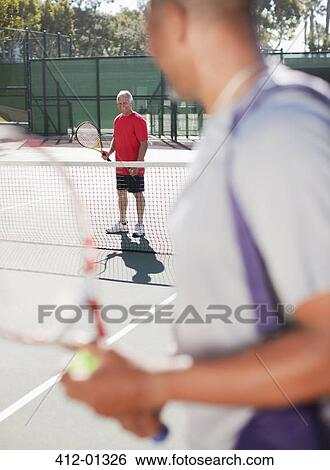 Older men playing tennis on court View Large Photo Image Stock Photograph - Older men playing tennis on court. Fotosearch