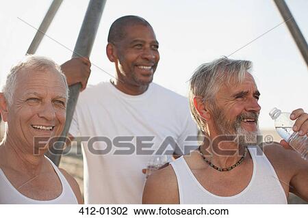 Older men relaxing outdoors together View Large Photo Image Stock Image - Older men relaxing outdoors together. Fotosearch
