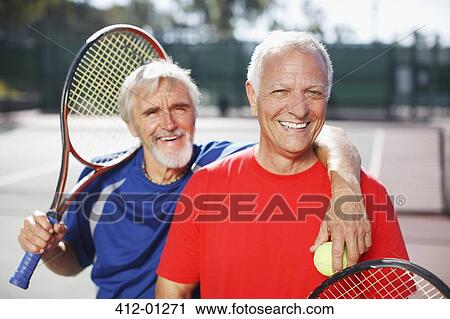 Older men smiling on tennis court View Large Photo Image Stock Image - Older men smiling on tennis court. Fotosearch