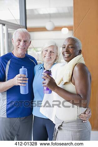 Older people drinking water after workout View Large Photo Image Stock Photo - Older people drinking water after workout. Fotosearch