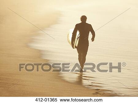 Older surfer carrying board on beach View Large Photo Image Stock Photography - Older surfer carrying board on beach. Fotosearch