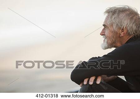 Older surfer sitting on beach View Large Photo Image Stock Photo - Older surfer sitting on beach. Fotosearch