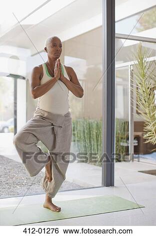 Older woman practicing yoga in home View Large Photo Image Stock Photograph - Older woman practicing yoga in home. Fotosearch