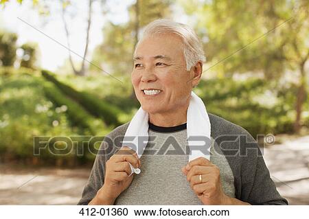 Stock Image - Smiling older man resting after workout. Fotosearch