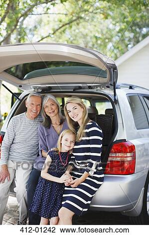 Family sitting in trunk of car View Large Photo Image Stock Image - Family sitting in trunk of car. Fotosearch