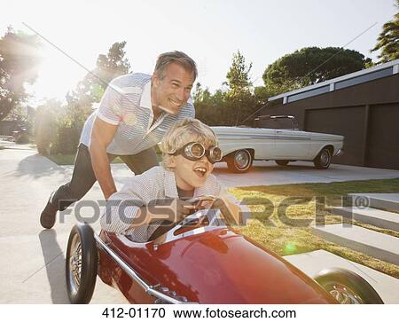 Father pushing son in go cart View Large Photo Image Stock Image - Father pushing son in go cart. Fotosearch