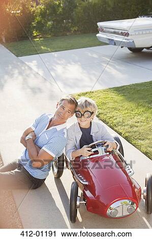 Father smiling with son in go cart View Large Photo Image Stock Image - Father smiling with son in go cart. Fotosearch