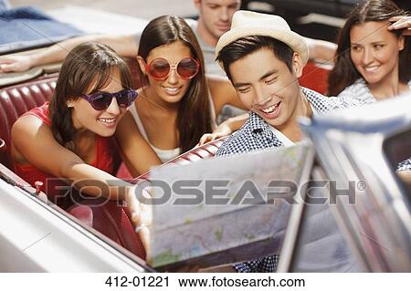 Friends reading road map in convertible View Large Photo Image Stock Image - Friends reading road map in convertible. Fotosearch