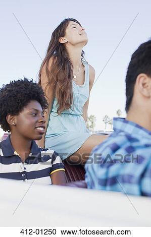 Friends sitting in convertible View Large Photo Image Stock Image - Friends sitting in convertible. Fotosearch