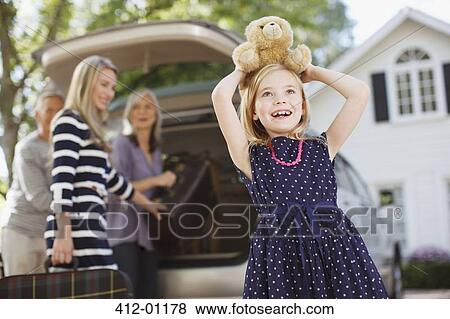 Stock Photo - Girl carrying teddy bear on her head. Fotosearch