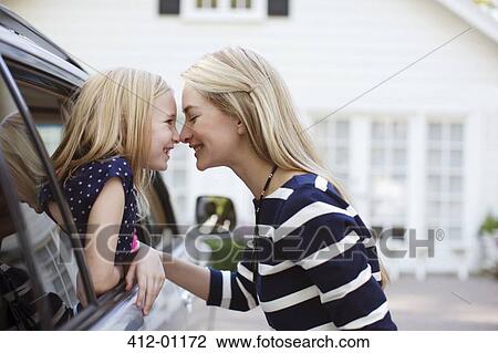 Mother and daughter touching noses in car View Large Photo Image Stock Image - Mother and daughter touching noses in car. Fotosearch