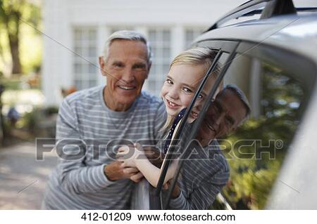 Older man talking to granddaughter in car window View Large Photo Image Stock Photo - Older man talking to granddaughter in car window. Fotosearch