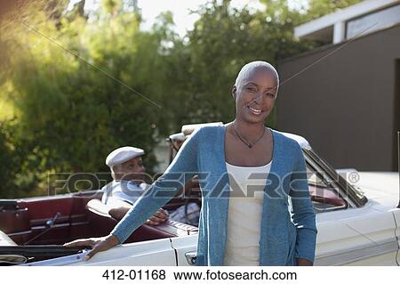 Older woman leaning on convertible View Large Photo Image Stock Photo - Older woman leaning on convertible. Fotosearch