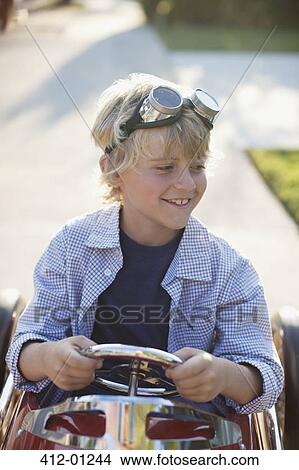 Picture - Smiling boy playing in go cart. Fotosearch