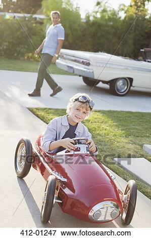 Smiling boy playing in go cart View Large Photo Image Stock Photo - Smiling boy playing in go cart. Fotosearch