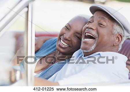 Smiling couple laughing in car View Large Photo Image Stock Photography - Smiling couple laughing in car. Fotosearch