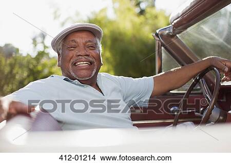 Smiling older man driving convertible View Large Photo Image Picture - Smiling older man driving convertible. Fotosearch