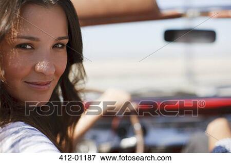 Smiling woman driving convertible View Large Photo Image Stock Photo - Smiling woman driving convertible. Fotosearch