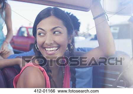 Smiling woman sitting in car View Large Photo Image Stock Photograph - Smiling woman sitting in car. Fotosearch