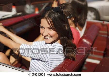 Smiling women driving convertible View Large Photo Image Stock Image - Smiling women driving convertible. Fotosearch