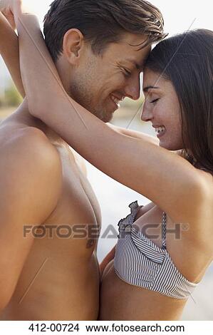 Close up of smiling couple hugging face to face View Large Photo Image Picture - Close up of smiling couple hugging face to face. Fotosearch