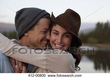 Close up portrait of happy couple hugging at lakeside View Large Photo Image Stock Image - Close up portrait of happy couple hugging at lakeside. Fotosearch