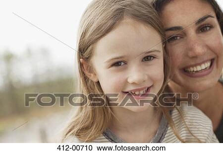 Close up portrait of smiling mother and daughter View Large Photo Image Stock Image - Close up portrait of smiling mother and daughter. Fotosearch