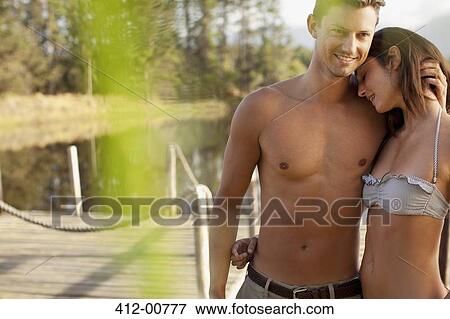 Couple hugging on dock View Large Photo Image Stock Photo - Couple hugging on dock. Fotosearch