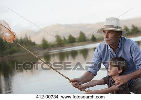 Grandfather and grandson fishing at lake View Large Photo Image Picture - Grandfather and grandson fishing at lake. Fotosearch