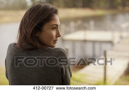 Pensive woman at lakeside View Large Photo Image Stock Photo - Pensive woman at lakeside. Fotosearch