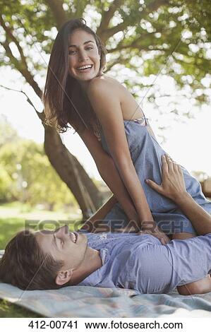 Portrait of smiling couple on blanket in grass View Large Photo Image Stock Image - Portrait of smiling couple on blanket in grass. Fotosearch