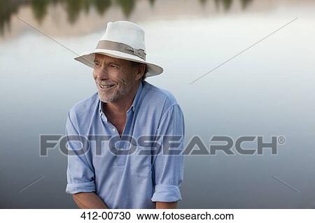 Smiling man at lakeside View Large Photo Image Stock Image - Smiling man at lakeside. Fotosearch