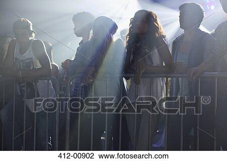 Crowd leaning on railing at concert View Large Photo Image Stock Image - Crowd leaning on railing at concert. Fotosearch