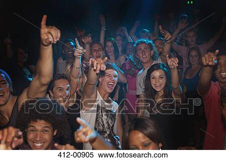 Stock Photography - Enthusiastic crowd cheering at concert. Fotosearch