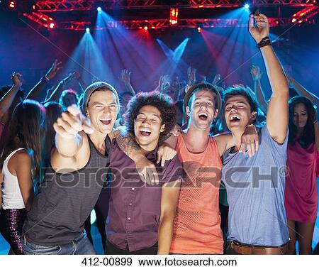 Enthusiastic friends cheering on dance floor of nightclub View Large Photo Image Stock Photo - Enthusiastic friends cheering on dance floor of nightclub. Fotosearch