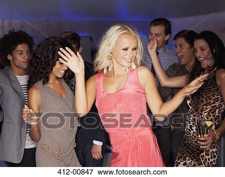 Stock Photo - Friends dancing at nightclub. Fotosearch
