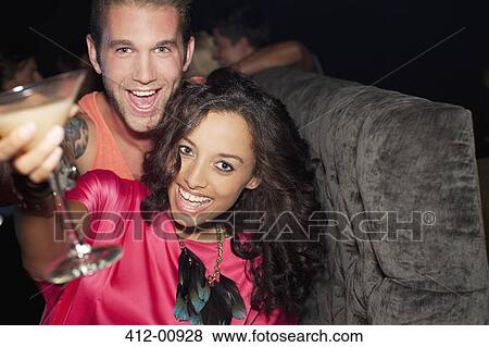 Portrait of enthusiastic couple drinking cocktail in nightclub View Large Photo Image Stock Photo - Portrait of enthusiastic couple drinking cocktail in nightclub. Fotosearch