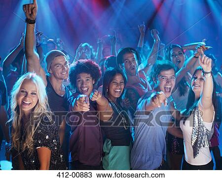 Stock Image - Portrait of enthusiastic crowd on dance floor of nightclub. Fotosearch