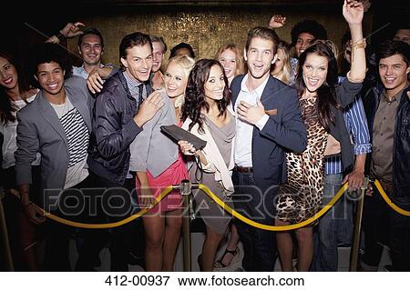 Portrait of enthusiastic crowd waiting in queue outside nightclub View Large Photo Image Stock Photo - Portrait of enthusiastic crowd waiting in queue outside nightclub. Fotosearch