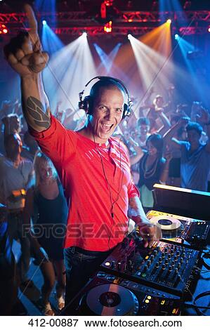 Portrait of enthusiastic DJ at turntable in nightclub View Large Photo Image Stock Photo - Portrait of enthusiastic DJ at turntable in nightclub. Fotosearch