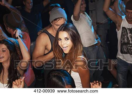 Portrait of smiling woman dancing in nightclub View Large Photo Image Stock Photo - Portrait of smiling woman dancing in nightclub. Fotosearch