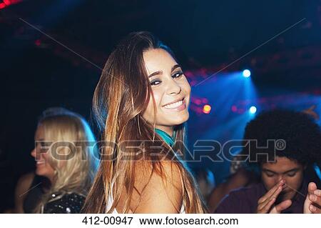 Portrait of smiling woman on dance floor of nightclub View Large Photo Image Stock Photo - Portrait of smiling woman on dance floor of nightclub. Fotosearch