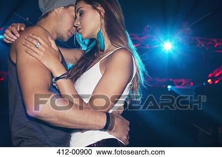 Stock Image - Sexy couple dancing under spotlight. Fotosearch