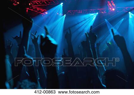 Silhouette of crowd cheering with arms raised at concert View Large Photo Image Stock Image - Silhouette of crowd cheering with arms raised at concert. Fotosearch