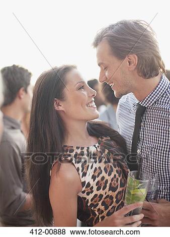 Smiling couple with cocktails hugging face to face View Large Photo Image Stock Photo - Smiling couple with cocktails hugging face to face. Fotosearch