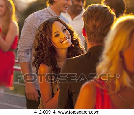 Smiling woman talking to man on sunny balcony View Large Photo Image Picture - Smiling woman talking to man on sunny balcony. Fotosearch