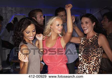 Stock Photo - Smiling women dancing in nightclub. Fotosearch