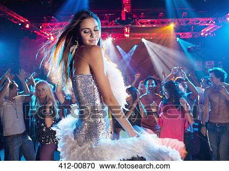 Woman in silver dress with feather boa dancing in nightclub View Large Photo Image Stock Image - Woman in silver dress with feather boa dancing in nightclub. Fotosearch