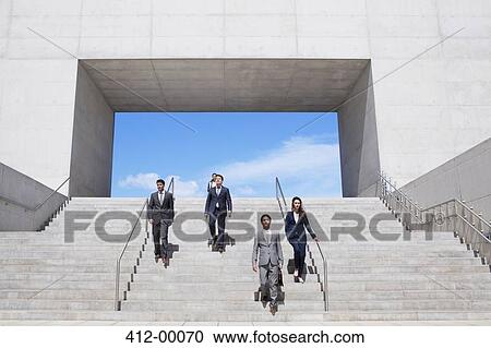 Business people descending urban stairs View Large Photo Image Stock Image - Business people descending urban stairs. Fotosearch